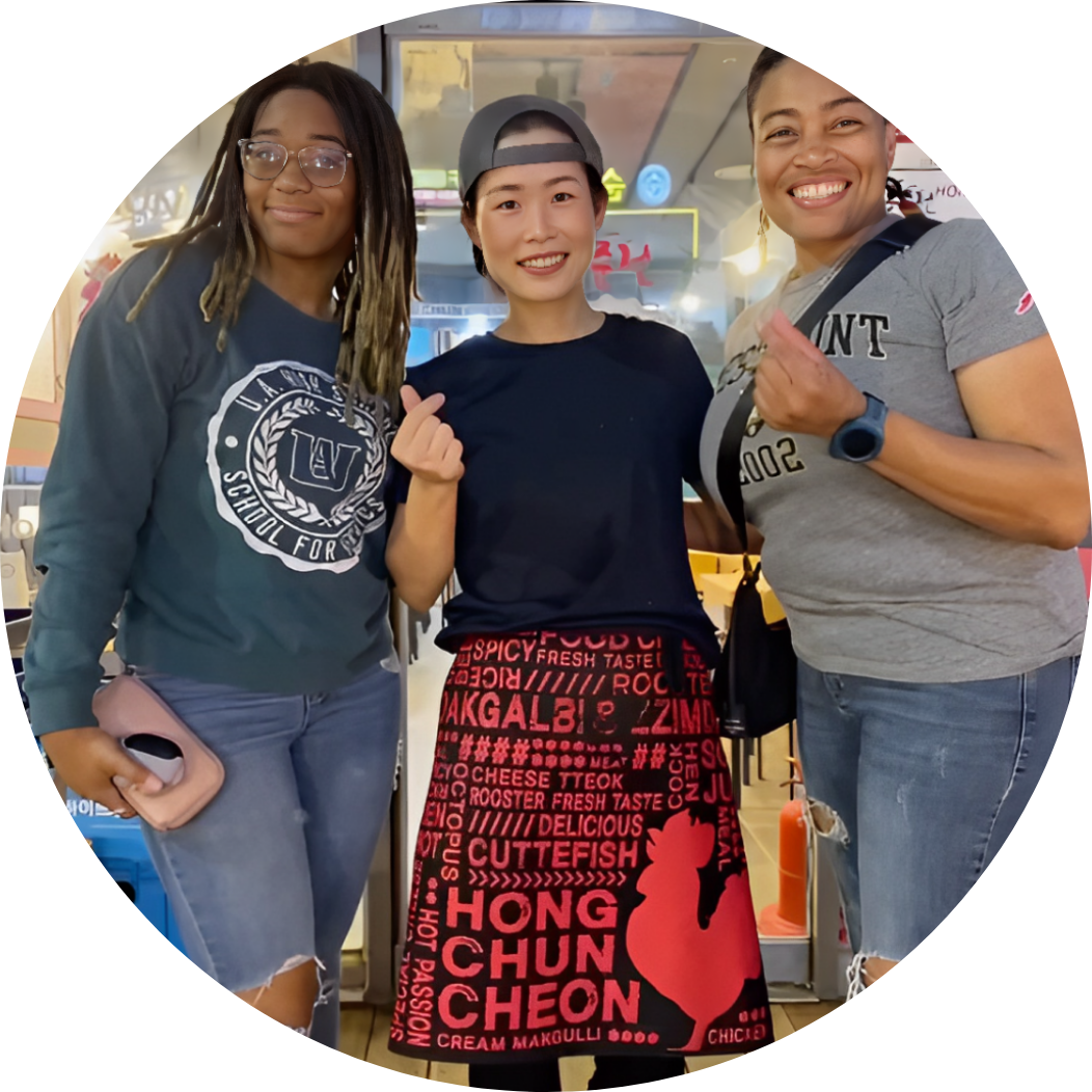 Dr. Andrea Peters shopping at an Asian store with her daughter. She photographed with the store owner and her daughter.