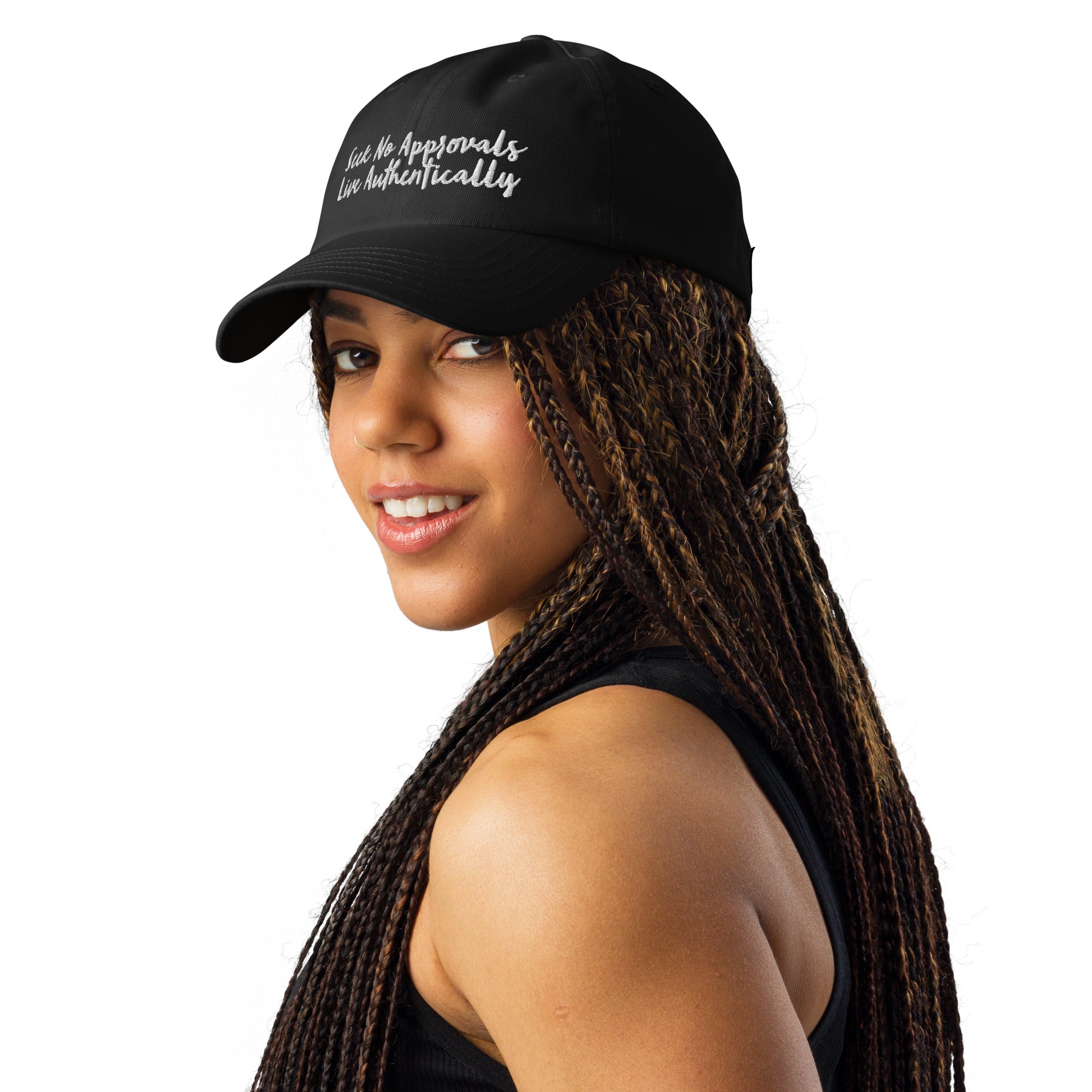 A Black woman with stylish braids looking sporty in a black Under Armour hat.