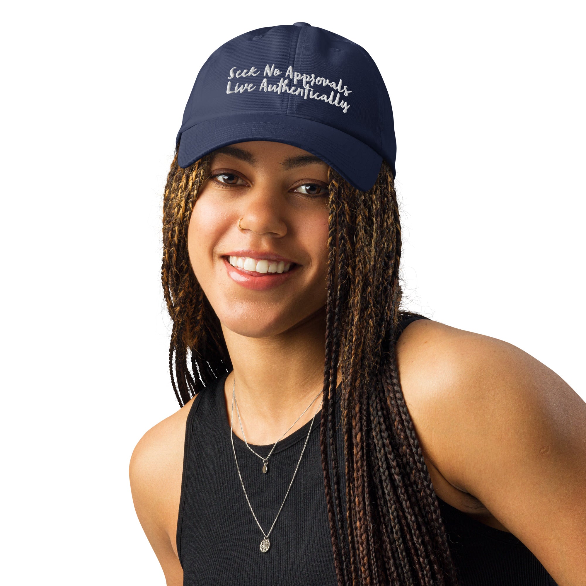 A Black woman with stylish braids looking sporty in a navy blue Under Armour hat.