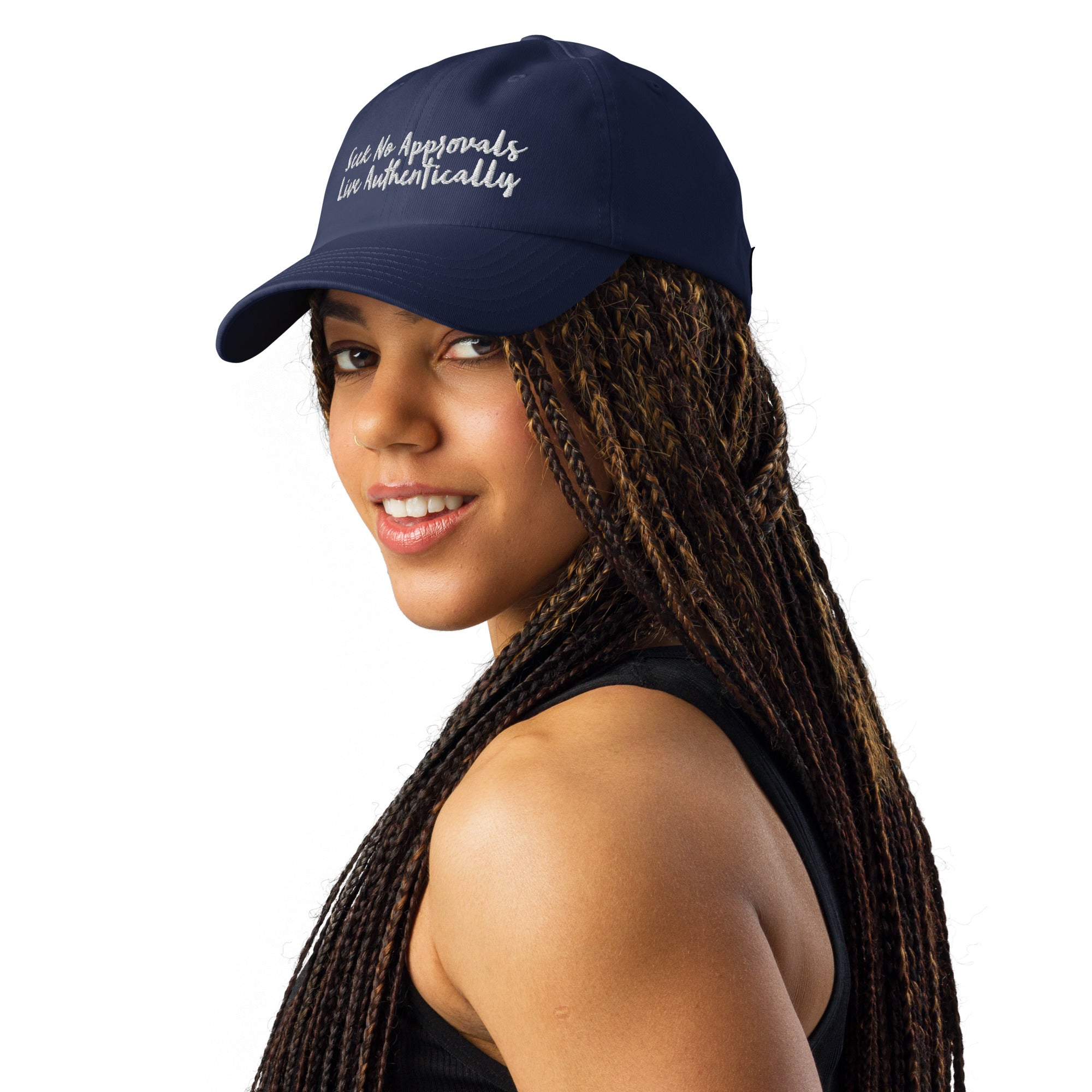 A Black woman with stylish braids looking sporty in a gray Under Armour hat.