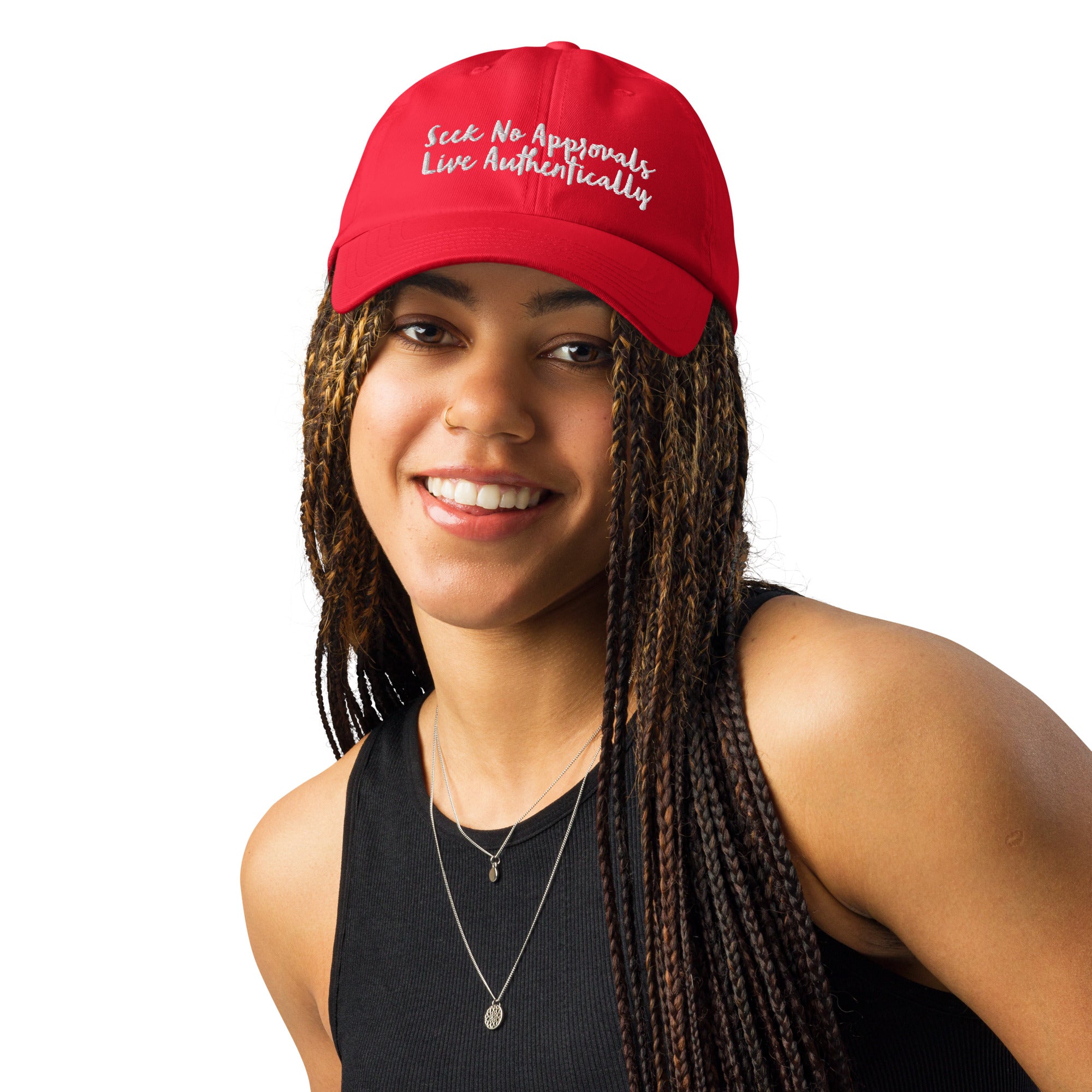 A Black woman with braids wearing a gray Under Armour hat in red.