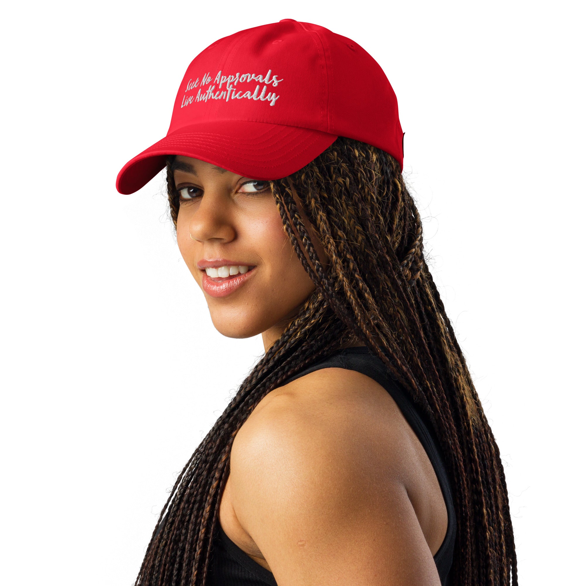 A Black woman with braids wearing a gray Under Armour hat in red.