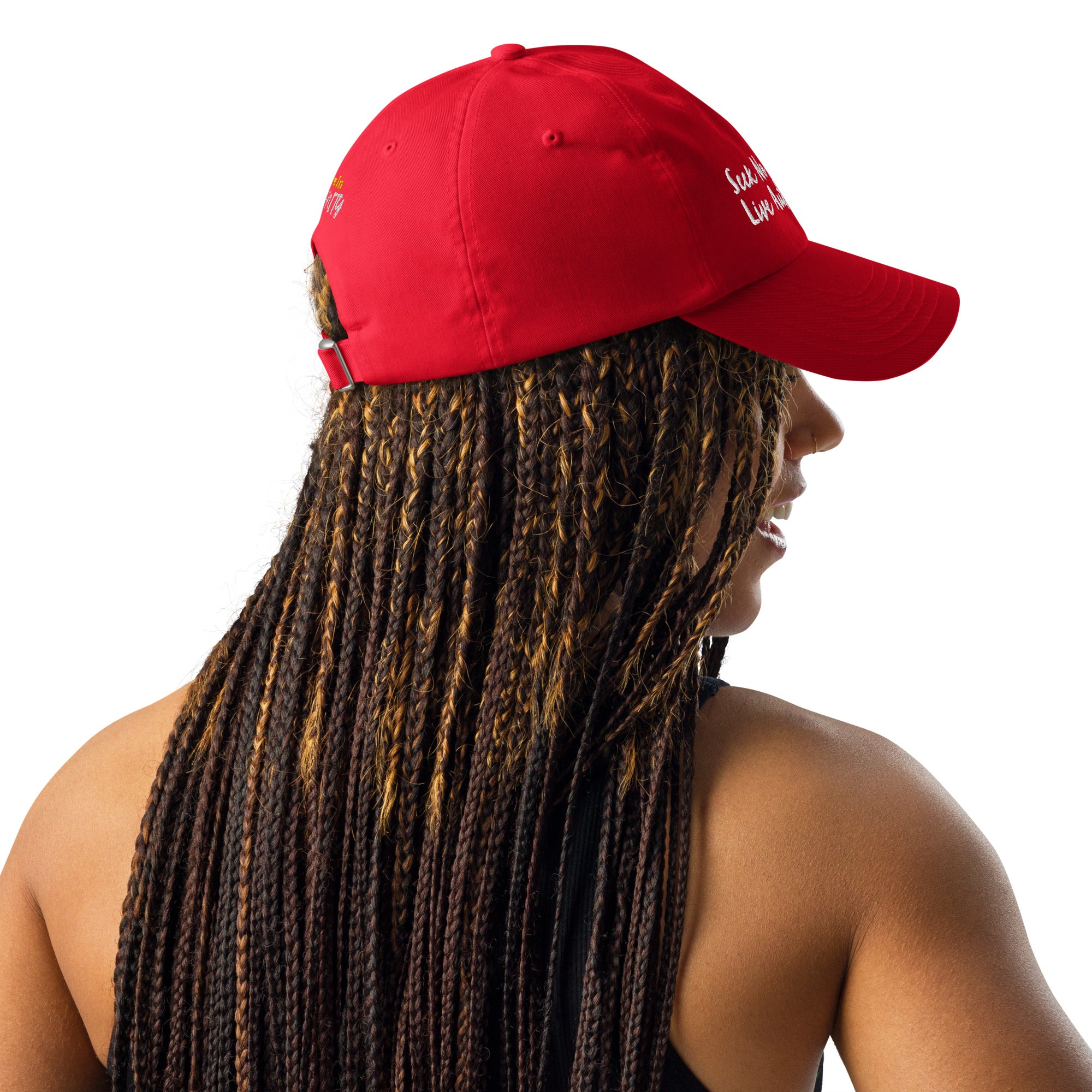 A Black woman with braids wearing a gray Under Armour hat in red.