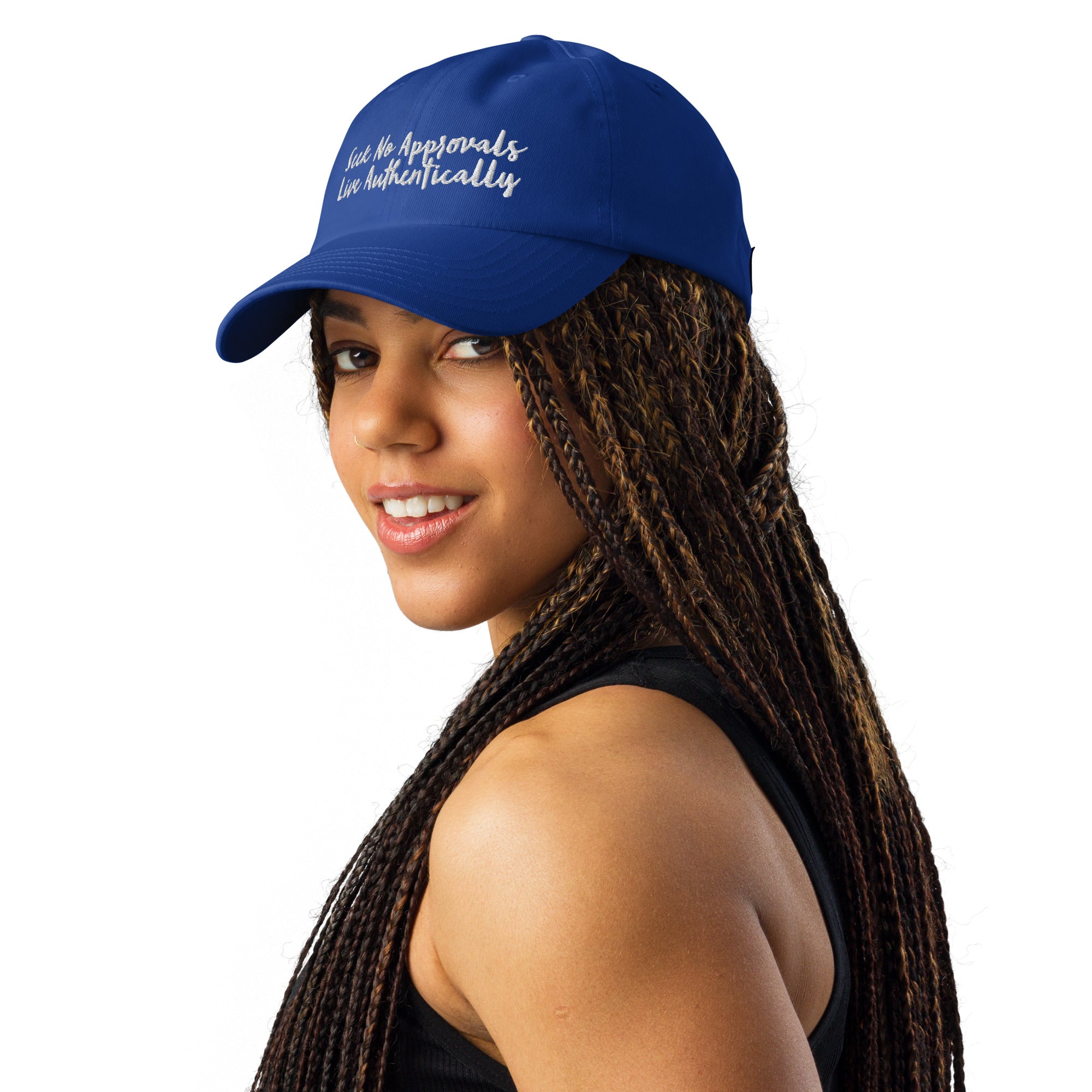 A gray Under Armour hat worn by a Black woman with braids, showcasing the hat's versatility and style.