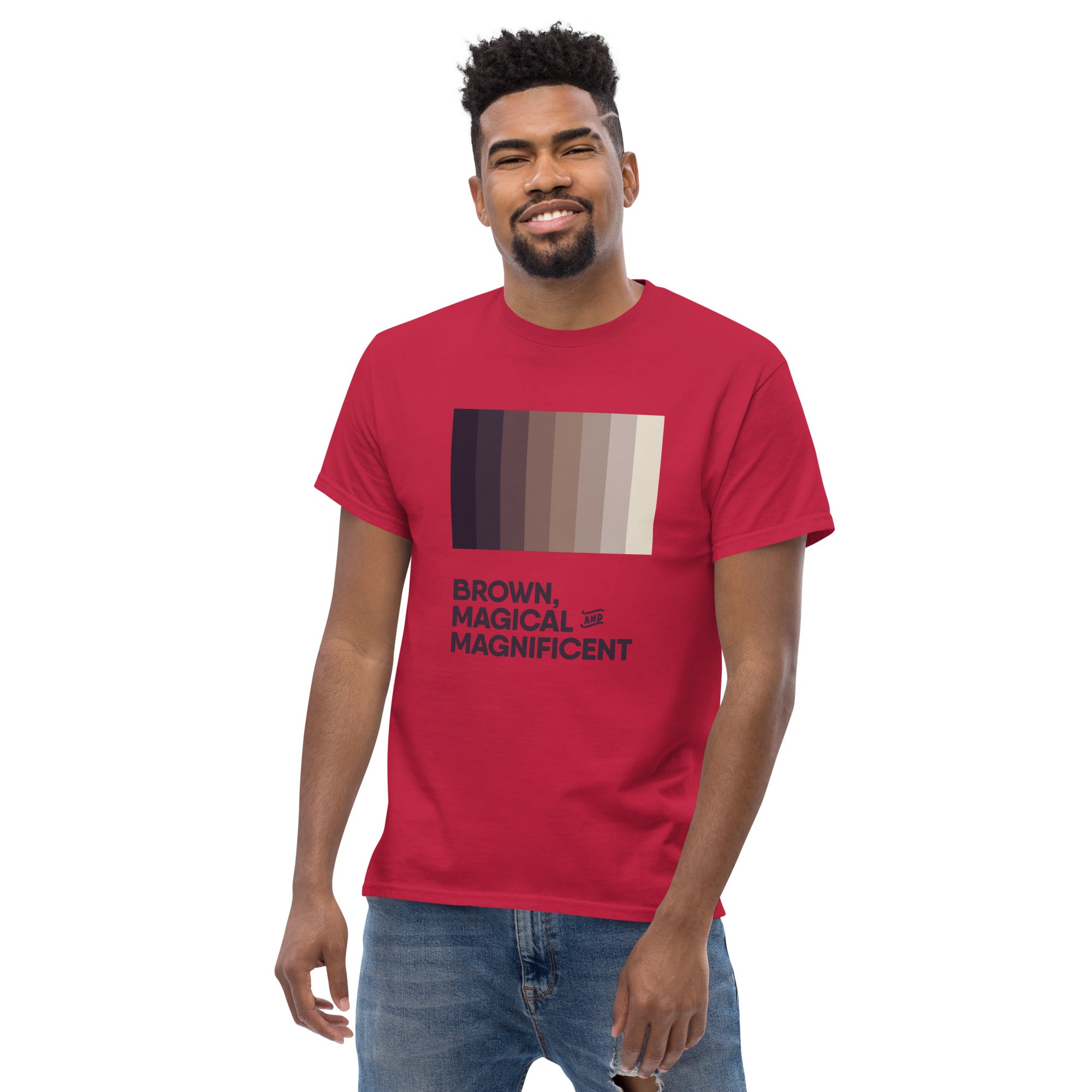 A Black man wearing a cardinal red shirt with a brown color gradient and the text "Brown, Magical, and Magnificent.