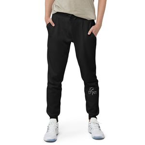 Our unisex black fleece sweatpants, modeled by a man. Perfect for lounging or staying active.