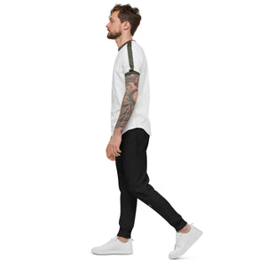 A man with tattoo sleeves confidently rocks a pair of black fleece sweatpants, expressing his unique style and embracing comfort.