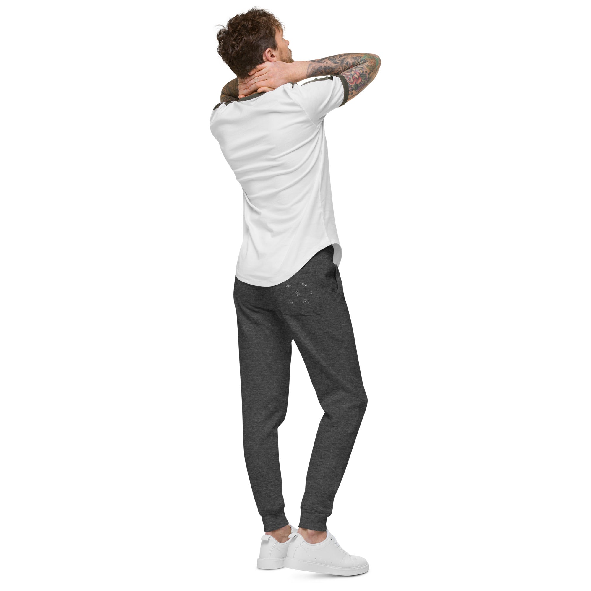 Our unisex military green fleece sweatpants, modeled by a man with tattoo sleeves. Perfect for lounging or staying active.