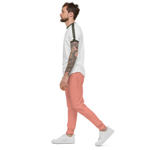 A man with tattoo sleeves confidently rocks a pair of dusty rose fleece sweatpants, expressing his unique style and embracing comfort.