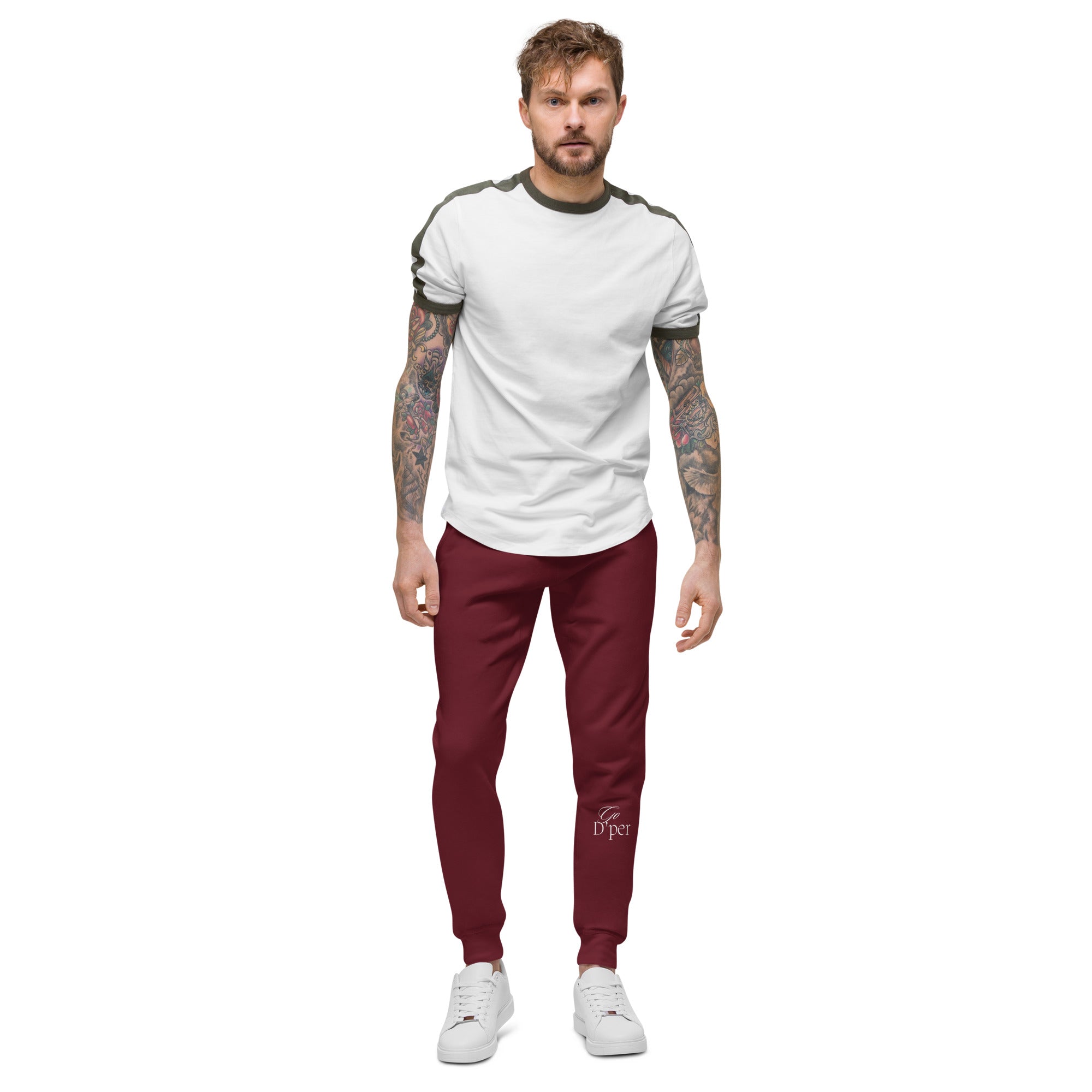 Our unisex maroon fleece sweatpants, modeled by a man with tattoo sleeves. Perfect for lounging or staying active.