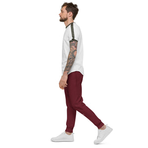 A man with tattoo sleeves confidently rocks a pair of maroon fleece sweatpants, expressing his unique style and embracing comfort.