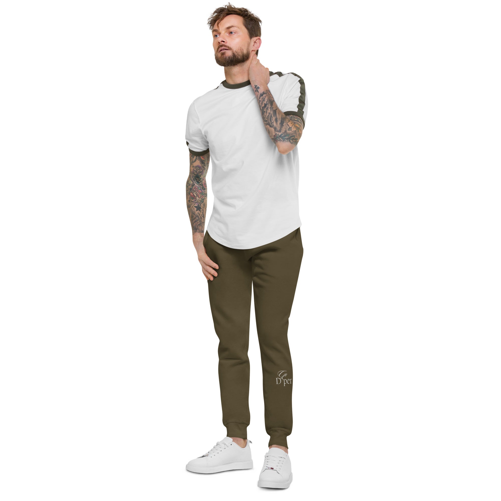 A man with tattoo sleeves showcasing a pair of comfortable, unisex military green fleece sweatpants.