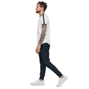 A man with tattoo sleeves confidently rocks a pair of navy blazer blue fleece sweatpants, expressing his unique style and embracing comfort.