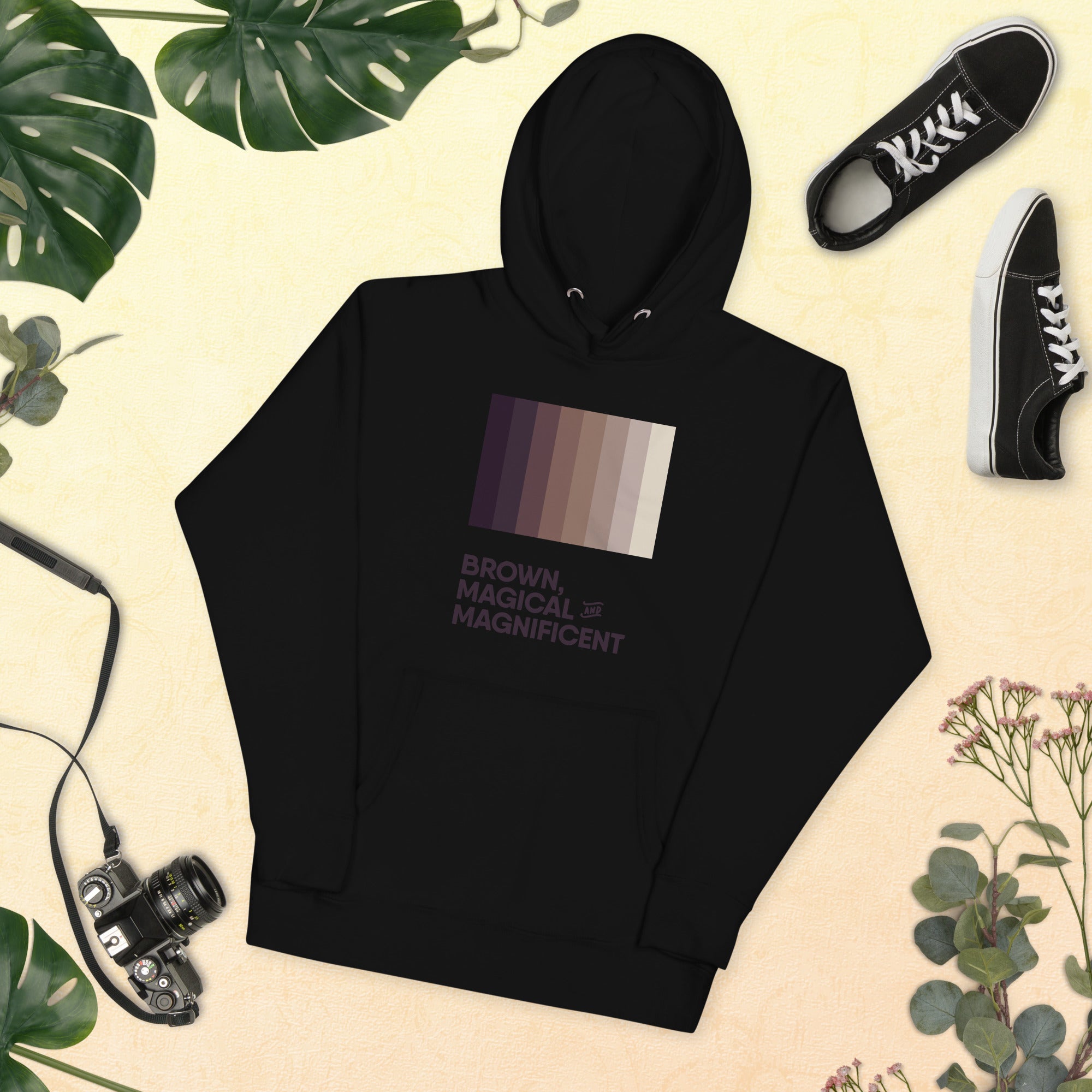 a black hoodie with a brown color gradient and the text "Brown, Magical, and Magnificent