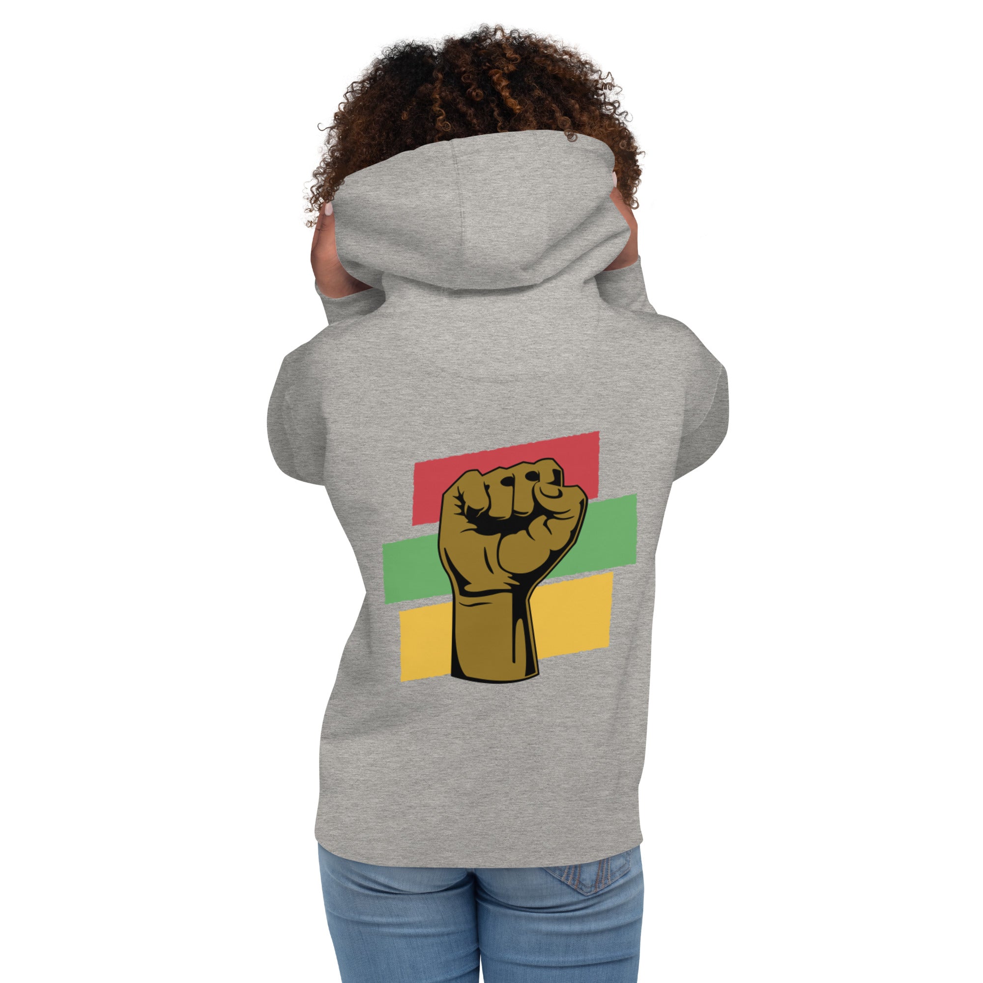 Back view of a gray hoodie with a raised black fist design. The model is a Black woman, showcasing the hoodie's empowering message.