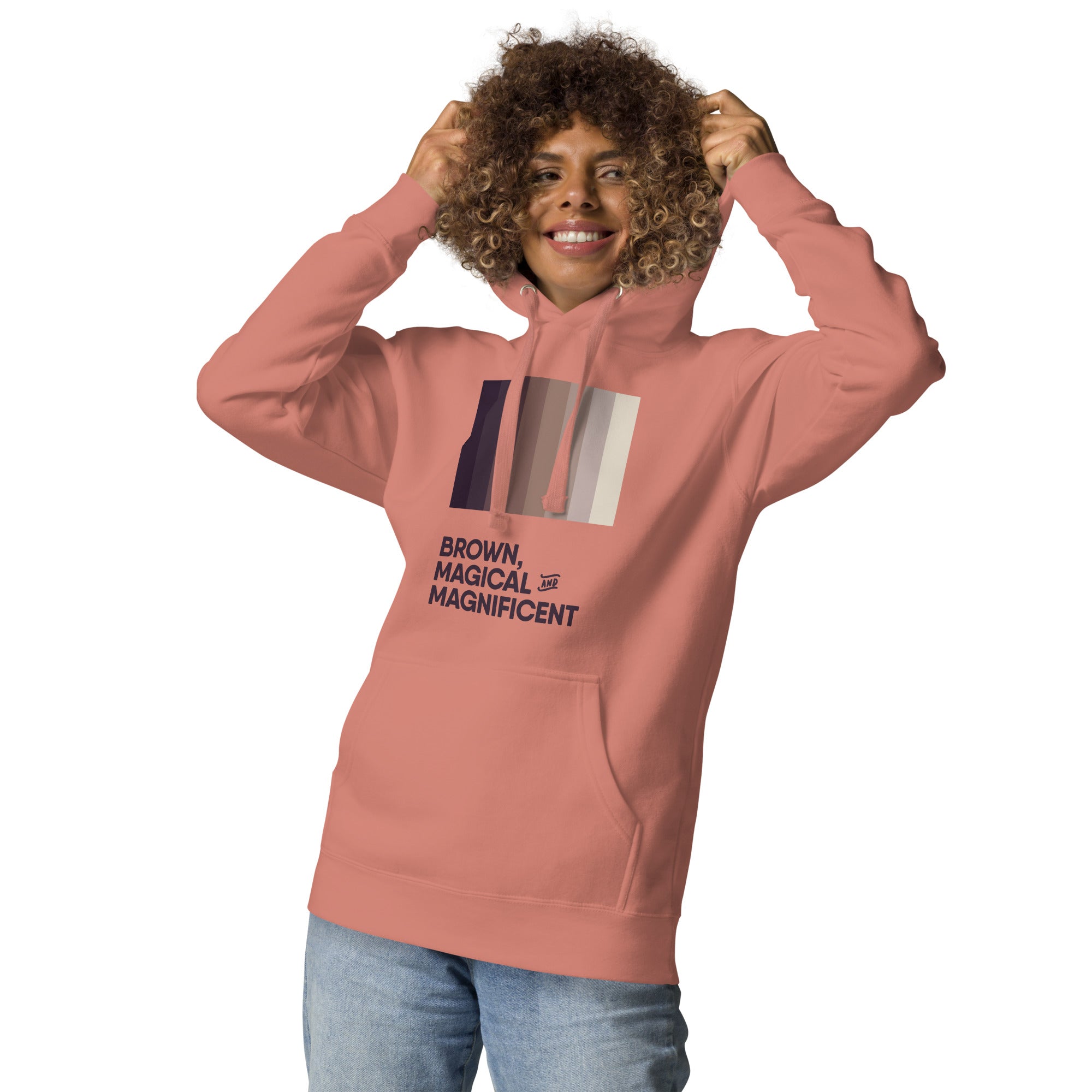 A Black woman in a dusty rose hoodie featuring a beautiful brown color gradient and the empowering message "Brown, Magical, and Magnificent."