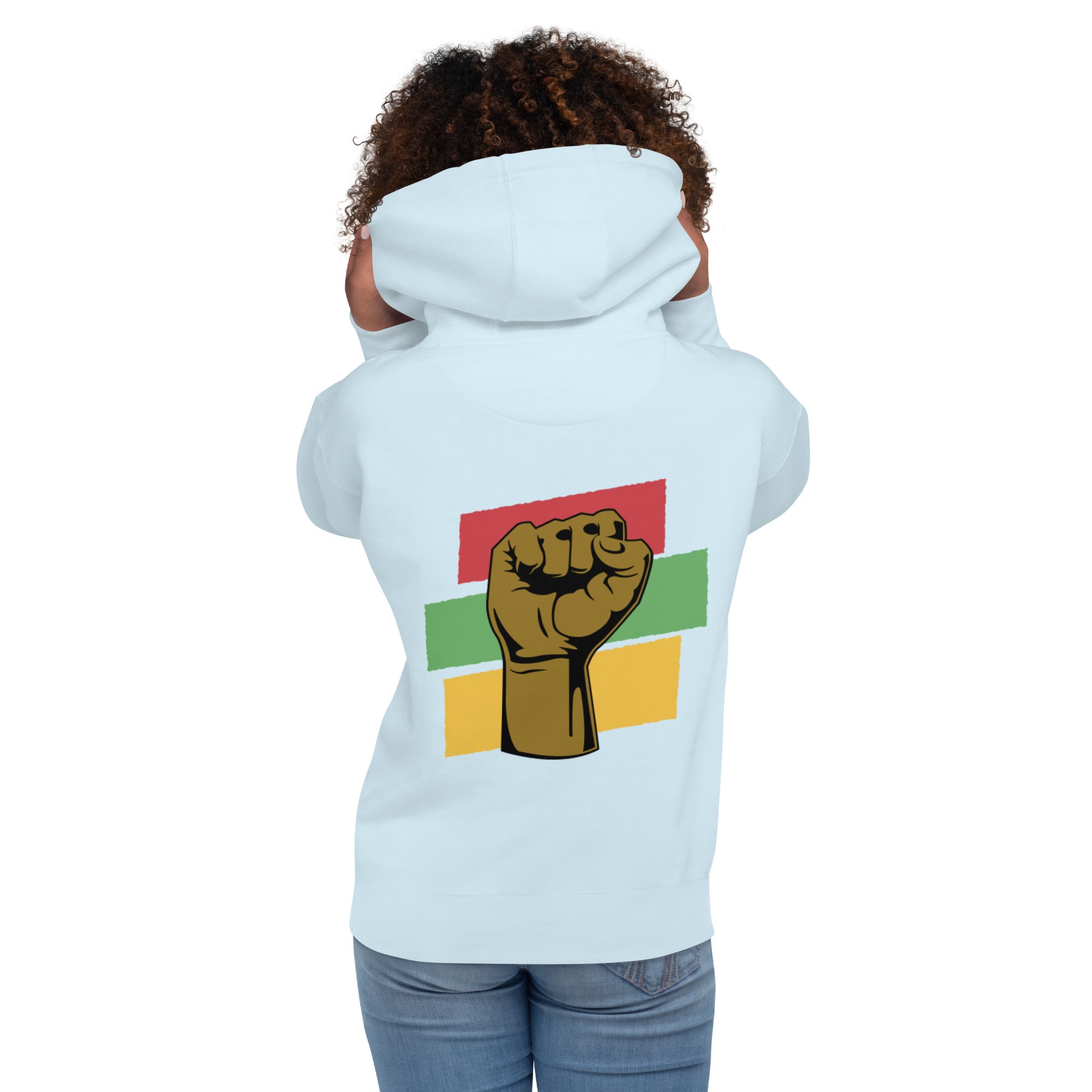 The back of a sky blue hoodie worn by a Black woman, featuring a raised black fist, symbolizing strength and solidarity.